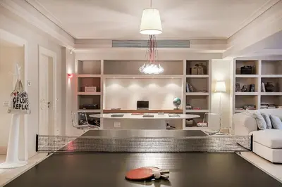 a living room with a couch and a table at GT Dreams Villa - Luxury Villa near the Athenian Riviera in Vari