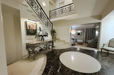 a large living room with a table and a staircase at GT Dreams Villa - Luxury Villa near the Athenian Riviera in Vari