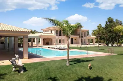 a house with a swimming pool in a yard at GT Dreams Villa - Luxury Villa near the Athenian Riviera in Vari