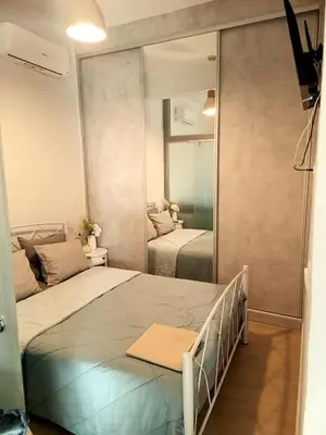 a bedroom with two beds and a mirror at PK luxury apartment in Athens