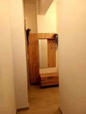 a hallway with a mirror and a wooden dresser at PK luxury apartment in Athens