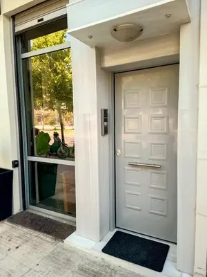 a front door of a house with a motorcycle in the window at PK luxury apartment in Athens