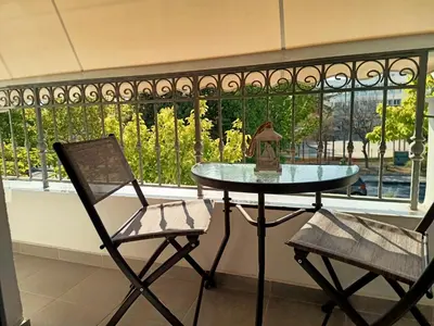 a table and two chairs in front of a window at PK luxury apartment in Athens