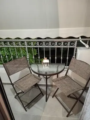 a table and two chairs on a balcony with a table at PK luxury apartment in Athens