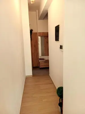 a corridor of a room with white walls and wooden floors at PK luxury apartment in Athens