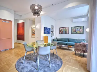 a living room with a glass table and chairs at 30one Kolonaki Apartment in Athens