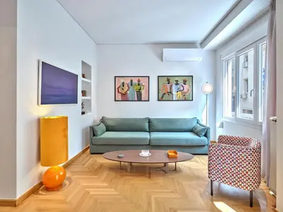a living room with a couch and a table at 30one Kolonaki Apartment in Athens