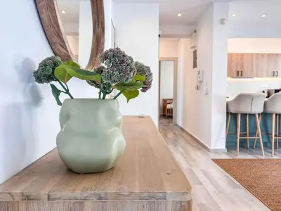 a vase filled with flowers sitting on a table at Boho Flat in Glyfada Center in Athens