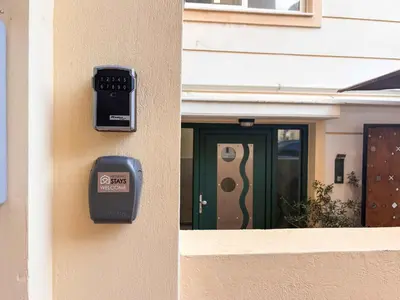 a meter on the side of a house with a door at Boho Flat in Glyfada Center in Athens