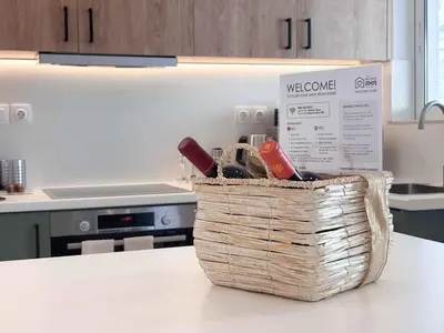 a basket of wine bottles on a counter in a kitchen at Boho Flat in Glyfada Center in Athens