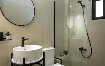 a bathroom with a white sink and a mirror at Gnamma Hotel in Athens
