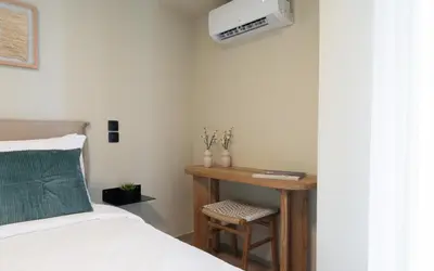 a bedroom with a bed and a table with a television at Gnamma Hotel in Athens