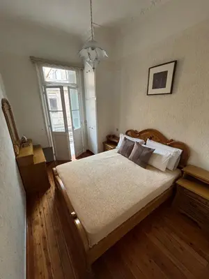 a bedroom with a large bed and a window at Neoclassical Athenian mansion in Athens