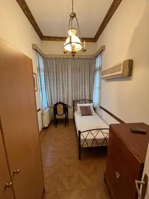a small room with a bed and a window at Neoclassical Athenian mansion in Athens