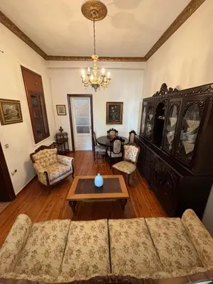 a living room with a couch and a table at Neoclassical Athenian mansion in Athens