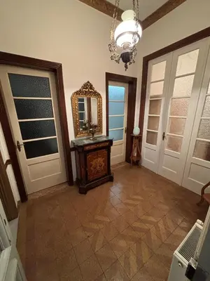 a room with a mirror and aoyer with doors at Neoclassical Athenian mansion in Athens