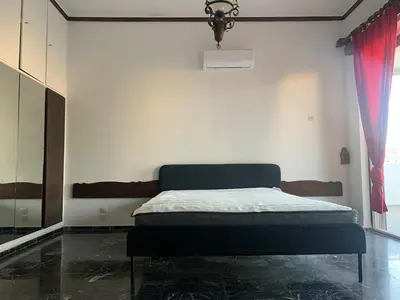 a bedroom with a bed in a room at Traditional Apartment in Varkiza in Vari