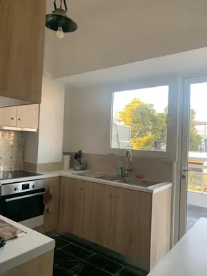 a kitchen with a sink and a window at Traditional Apartment in Varkiza in Vari