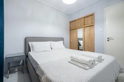 a bedroom with a white bed with towels on it at Petralona Hideaway - Comfort for 4 by ΜΡS in Athens