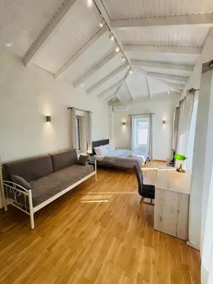 a living room with a couch and a bed at East Side of Acropolis in Athens