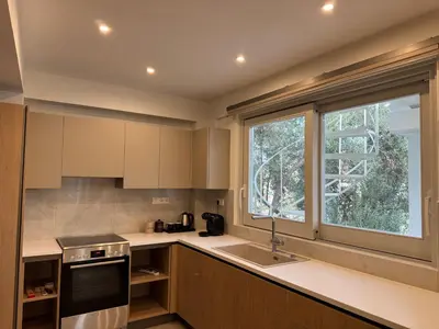 a kitchen with a sink and a window at East Side of Acropolis in Athens