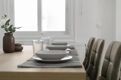 a dining room table with plates and bowls and glasses at Ilotana in Athens