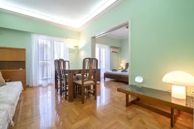 a living room with a table and chairs and a couch at Metaxourgeio Metro Apartment-Comfort for 3 by ΜΡS in Athens