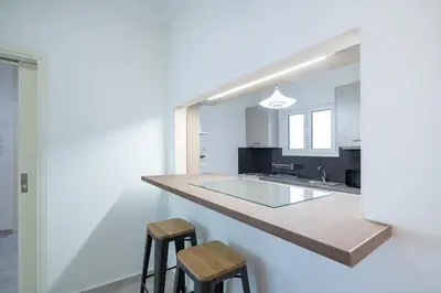 a kitchen with a counter and two stools at Metaxourgeio Metro Apartment-Comfort for 3 by ΜΡS in Athens