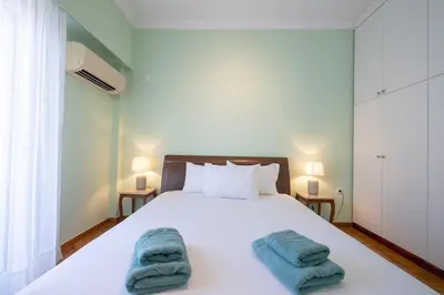 a bedroom with a white bed with two towels on it at Metaxourgeio Metro Apartment-Comfort for 3 by ΜΡS in Athens