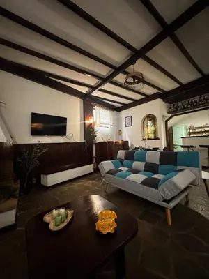 a living room with a blue couch and a table at Vintage Studio - Great for Travelers in Transit in Koropíon