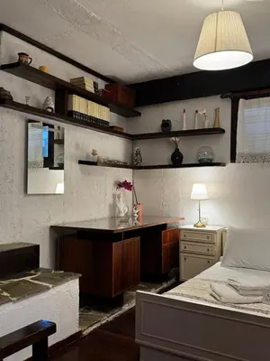 a bedroom with a bed and a desk and a table at Vintage Studio - Great for Travelers in Transit in Koropíon