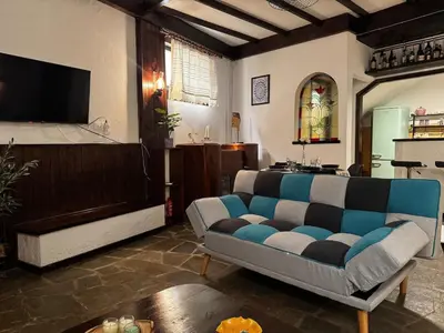 a living room with a couch and a tv at Vintage Studio - Great for Travelers in Transit in Koropíon