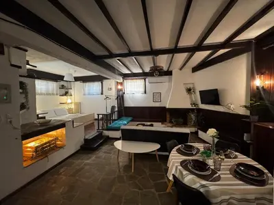 a room with two tables and a kitchen in a restaurant at Vintage Studio - Great for Travelers in Transit in Koropíon