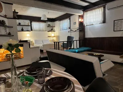 a living room with a table and a couch at Vintage Studio - Great for Travelers in Transit in Koropíon