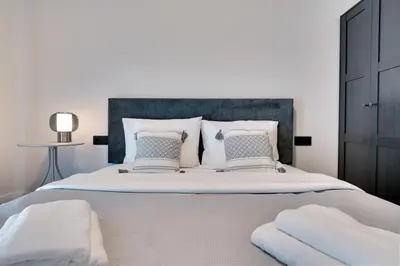 a bedroom with a large bed with two pillows at Skyline Spa Athens 010 in Athens