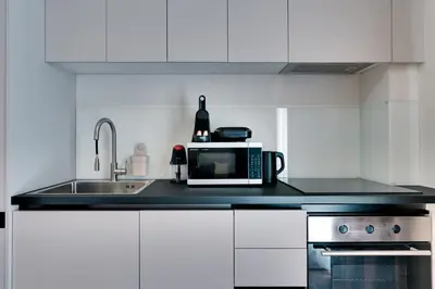 a kitchen with a microwave and a sink at Skyline Spa Athens 010 in Athens