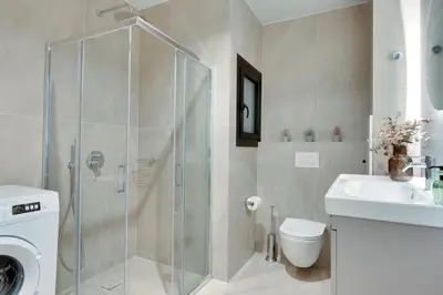 a bathroom with a shower and a toilet and a sink at Skyline Spa Athens 010 in Athens