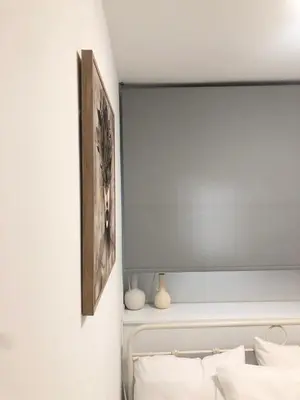 a bedroom with a bed with a picture on the wall at Aiolos Sea loft central market Palaio Faliro in Athens