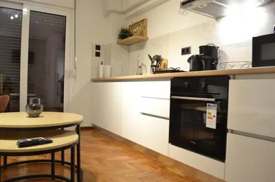 a kitchen with a stove and a small table at Aiolos Sea loft central market Palaio Faliro in Athens