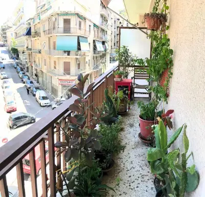 a balcony with a bunch of plants and a street at Sunny room in the heart of the city in Athens