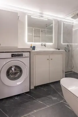 a white bathroom with a washing machine and a sink at Bright 2BR Apt, Athens Base Near Sea & City in Athens