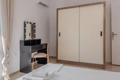a dressing room with a mirror and a dressing table at Bright 2BR Apt, Athens Base Near Sea & City in Athens