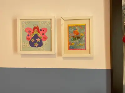 two pictures of flowers on a wall at Acropolis Happy Place in Athens