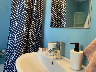 a bathroom with a sink and a mirror at Acropolis Happy Place in Athens