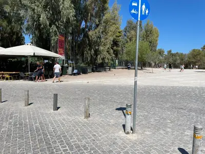 a blue street sign in the middle of a park at Acropolis Happy Place in Athens