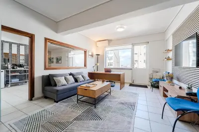 a living room with a couch and a table at Piraeus PortView Apt in Piraeus