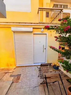 a garage with two benches in front of a building at sea soul house in Athens