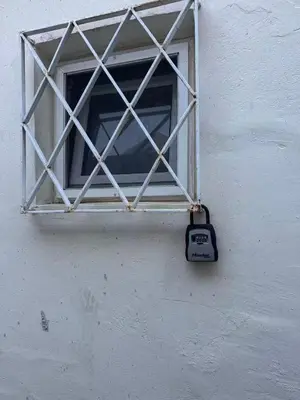 a window on the side of a building with a clock on it at sea soul house in Athens