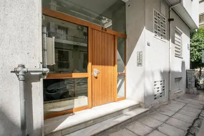a front door of a house with an open window at Serenity - 1-BR Apartment in Zografou in Athens