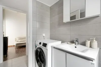 a bathroom with a washing machine and a sink at Serenity - 1-BR Apartment in Zografou in Athens